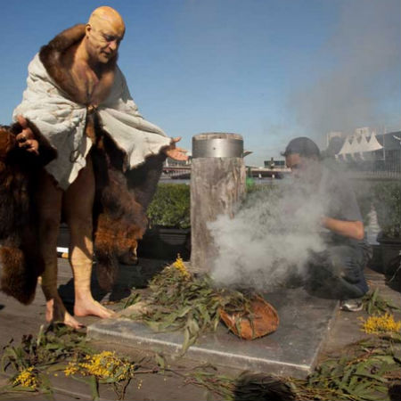 Indigenous Elder Bill Nicholson Jnr performing a smoking ceremony at the flag-raising ceremony at Enterprize Park.